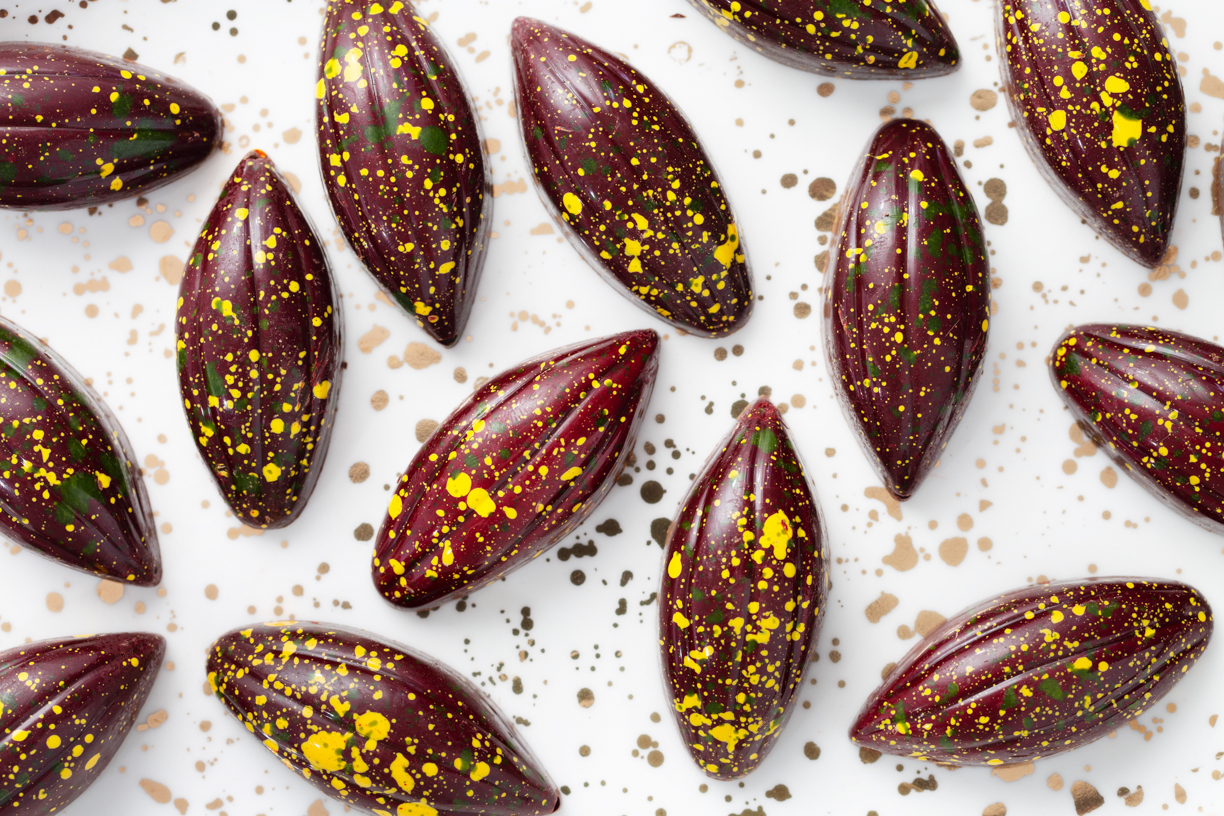 Overhead photo of several cocoa-pod shaped bon bons